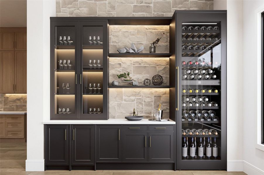 Sophistication meets purpose in this striking wine and bar area, where glass cabinetry and accent lighting showcase a curated backdrop of stone and wood. With its clean lines, built-in sink, and ample storage, this design evokes a refined space ready for elegant hosting or quiet evenings alike.