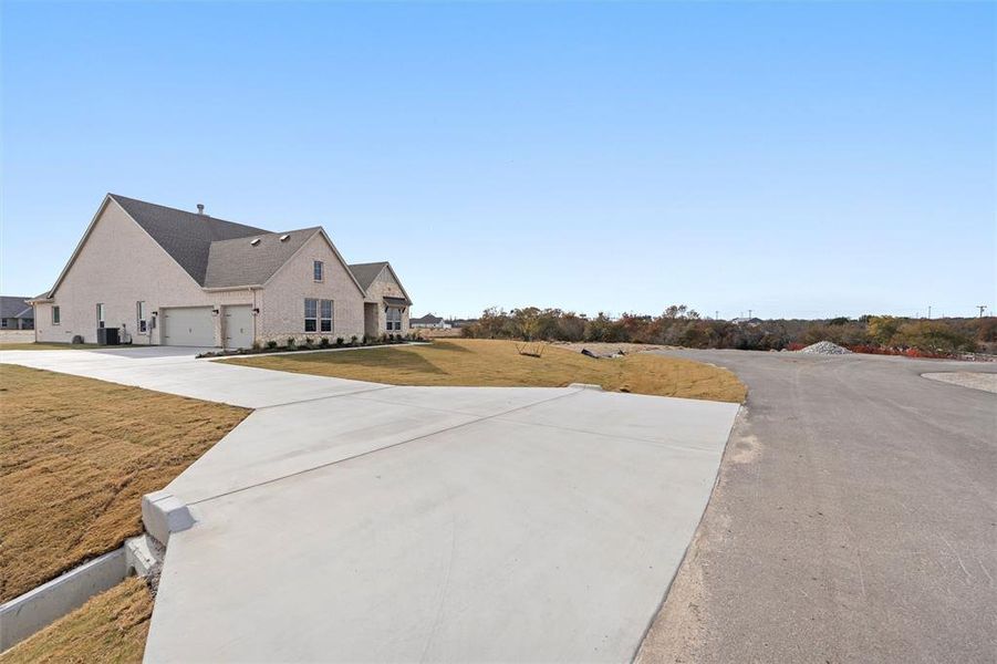 Front exterior of a new home in Eagle Ridge Estates, Weatherford, TX, highlighting curb appeal (Image 23).
