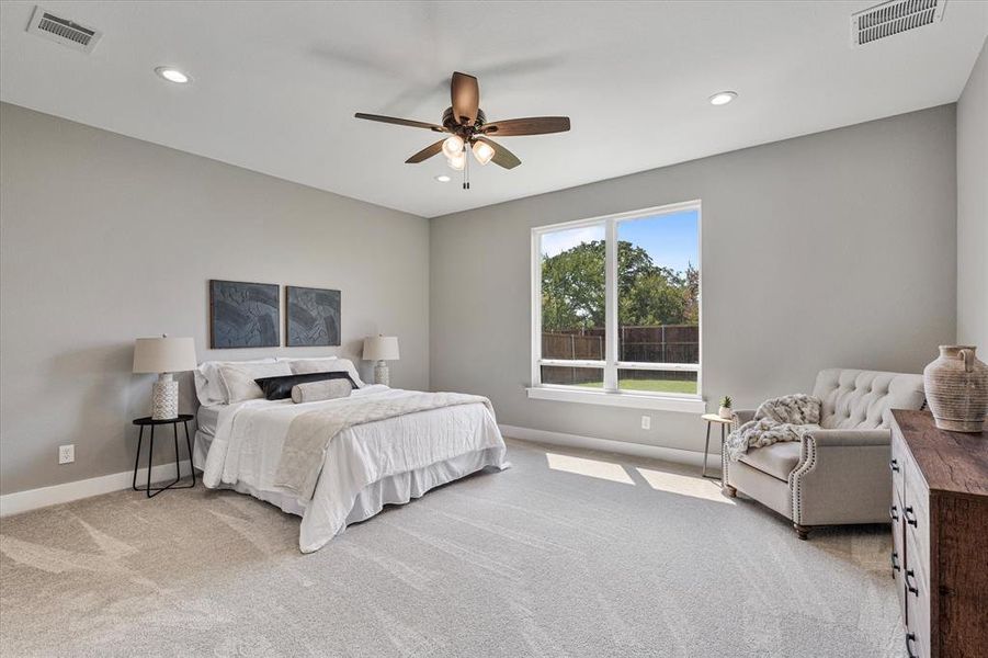 Carpeted bedroom with ceiling fan