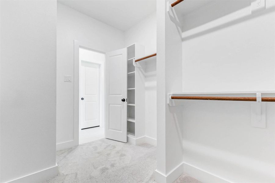 Primary Closet with a view of more shelving. Primary Closet with a view of more shelving.