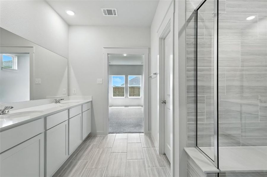 Bathroom with a shower stall and double vanity Bathroom with a shower stall and double vanity
