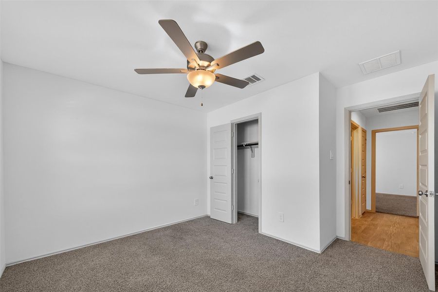 Another view of one of the secondary bedrooms, features paneled doors, ceiling fan, and a nice sized closet. This versatile space could easily serve as a home office or gameroom Another view of one of the secondary bedrooms, features paneled doors, ceiling fan, and a nice sized closet. This versatile space could easily serve as a home office or gameroom