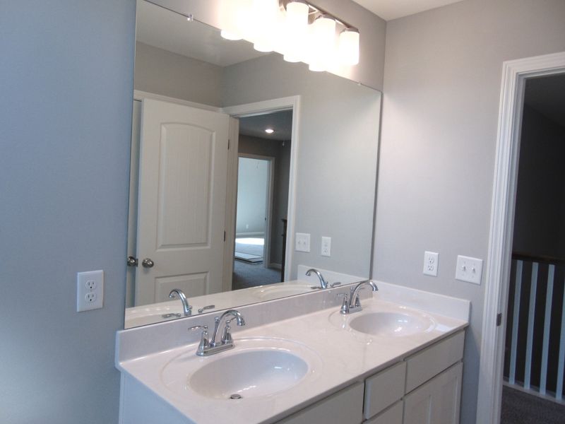 The second bath is a tub shower combo, includes two sleek sinks, as well as an elongated toilet, an elongated toilet, and plenty of cabinet space.