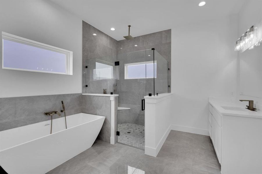 Bathroom featuring shower with separate bathtub, tile patterned floors, and vanity