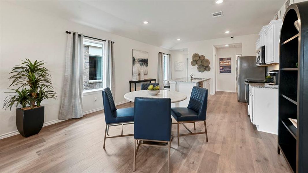 Dining space with light wood-type flooring and recessed lighting Dining space with light wood-type flooring and recessed lighting