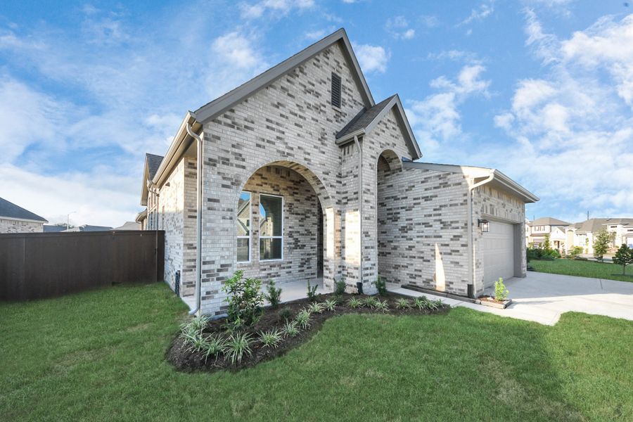 Front exterior of a new home in Meridiana, Manvel, TX, highlighting curb appeal (Image 30).