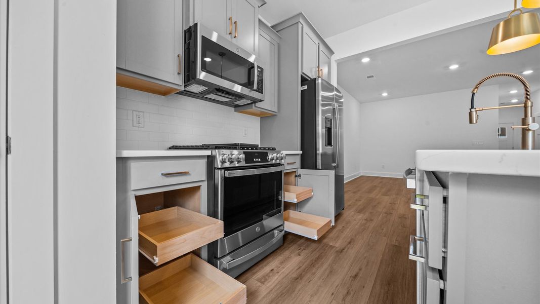 Superior craftsmanship shines in this modern kitchen with a space-saving island and open flow located in Spartanburg, SC