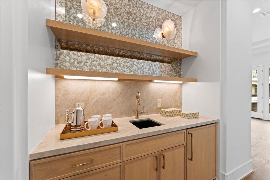 Primary coffee area- Stylish shelving and antique mirror with ambient lighting.