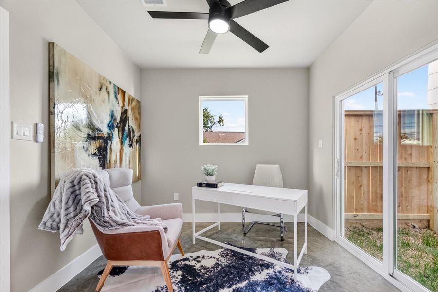 A sliding glass door provides direct access to the private backyard from the first-floor bedroom, a rare feature in urban new construction. Polished concrete floors and neutral walls make this a clean canvas ready for any use.