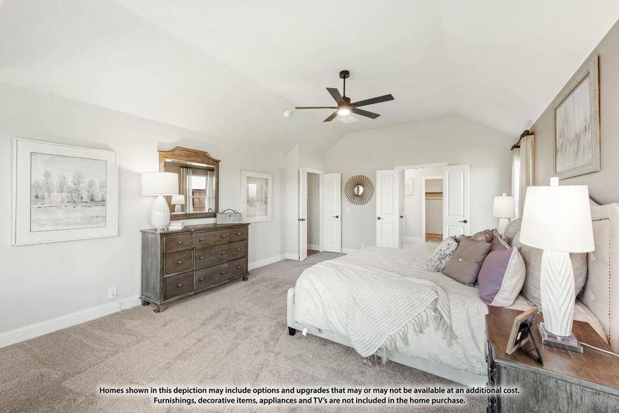 Master bedroom with vaulted ceiling, ceiling fan, carpet flooring, and wood dresser with mirror