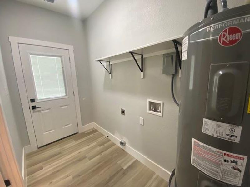 A well-organized utility space awaits your personal touch with light wood-style flooring. A well-organized utility space awaits your personal touch with light wood-style flooring.