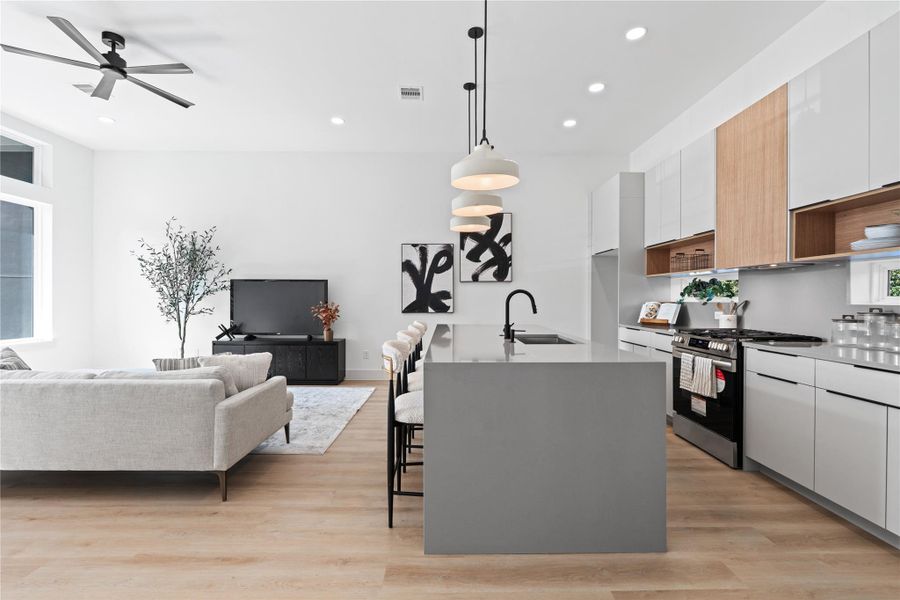 A sleek kitchen silhouette that flows effortlessly into the bright, open living room. A sleek kitchen silhouette that flows effortlessly into the bright, open living room.