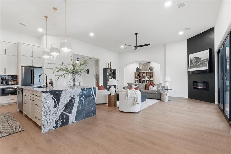 Open-concept living space featuring wood-finish flooring throughout