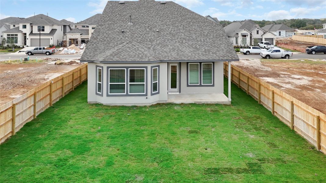 Rear view of house with a residential view, a shingled roof, and a fenced backyard