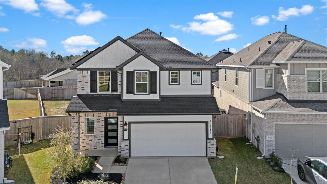 Front exterior of a new home in Emory Glen, Magnolia, TX, highlighting curb appeal (Image 18).