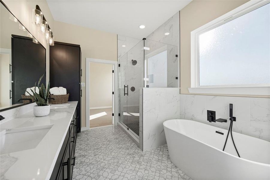 Bathroom with vanity, separate shower and tub, and tile walls