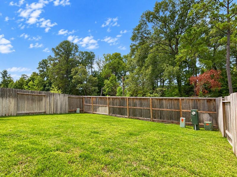 Exterior details and patio area of a home in Woodforest, Montgomery (Image 23).