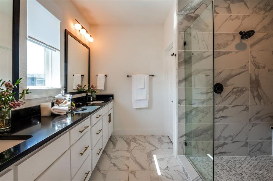 Tastefully appointed primary bathroom with over-sized shower