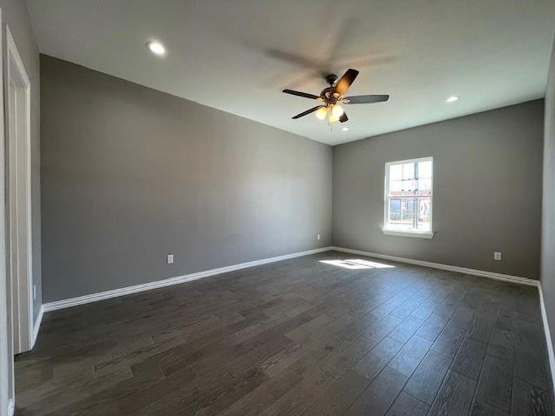 Master bedroom featuring wood-style floors, baseboards, a ceiling fan, and recessed lighting Master bedroom featuring wood-style floors, baseboards, a ceiling fan, and recessed lighting