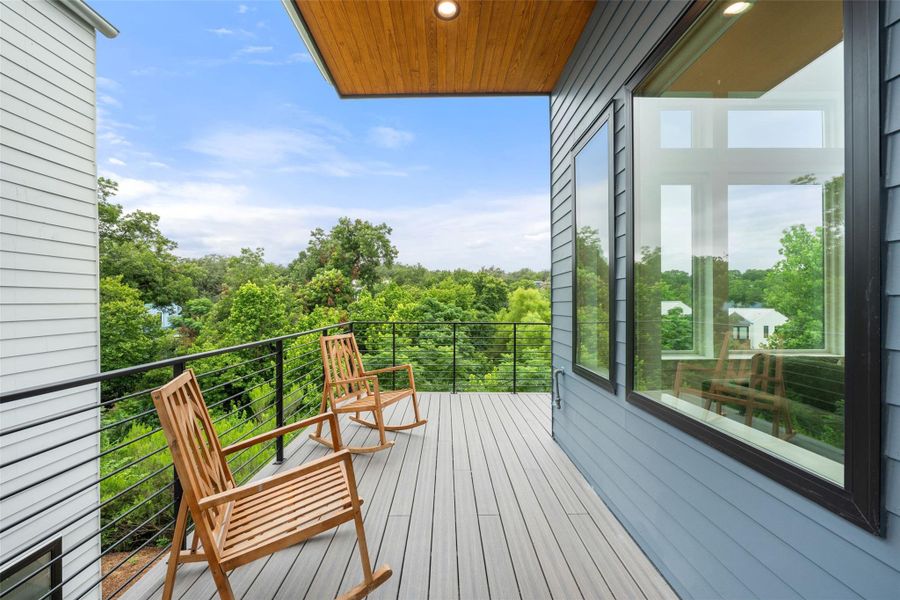 Perched above the tree line, a serene private balcony offers tranquil outdoor living. Perched above the tree line, a serene private balcony offers tranquil outdoor living.