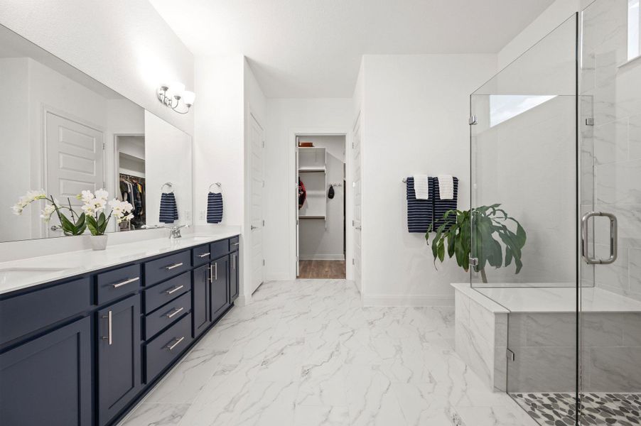 The primary bathroom offers a calming, spa-inspired design complete with a large walk-in shower and an impressive closet The primary bathroom offers a calming, spa-inspired design complete with a large walk-in shower and an impressive closet
