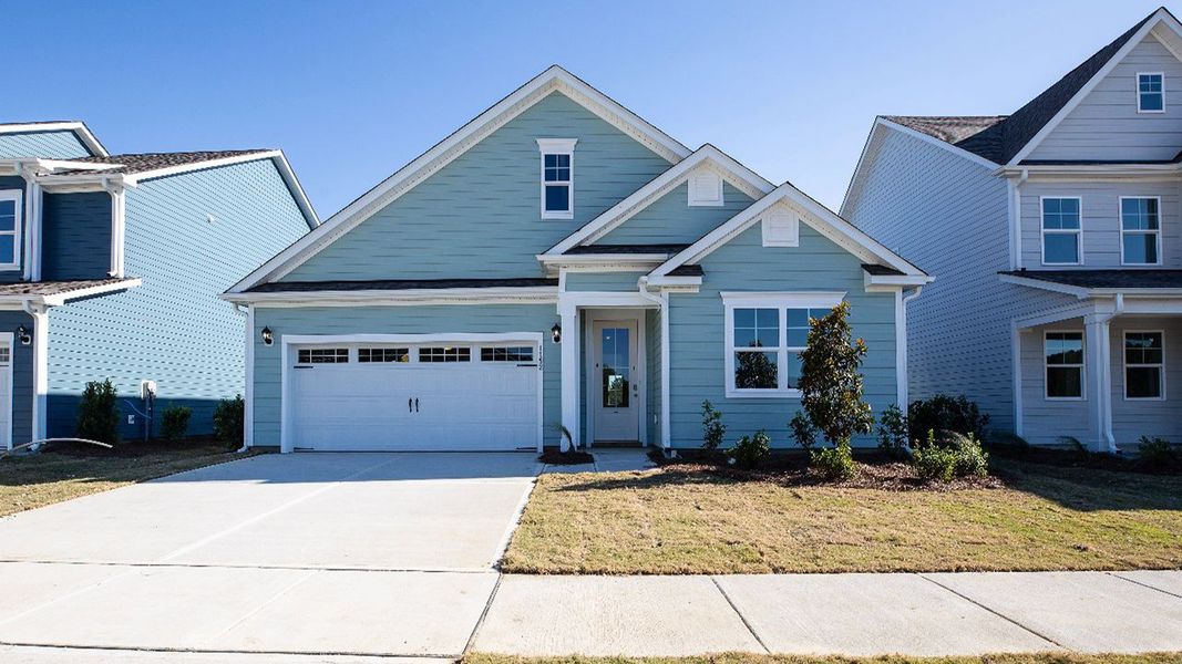 Front exterior of a new home in Indigo Preserve, Leland, NC, highlighting curb appeal (Image 1).