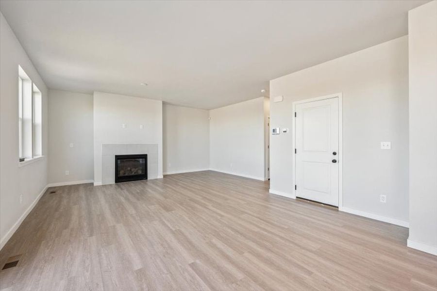 A room with a fireplace and a wood floor.