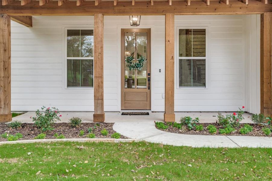 Doorway to property with covered porch