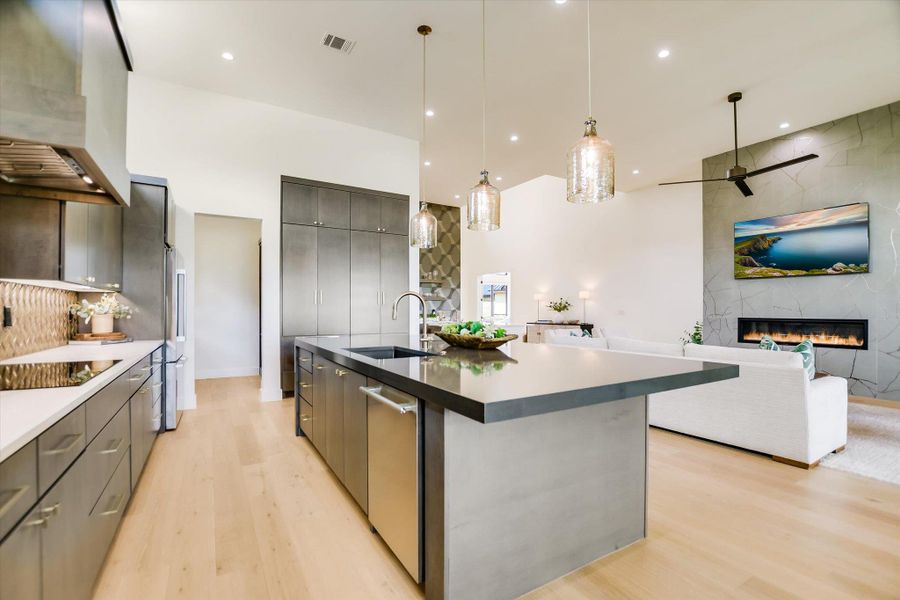 Vast vaulted ceilings complement an inviting open-concept kitchen and living area, ideal for entertaining.