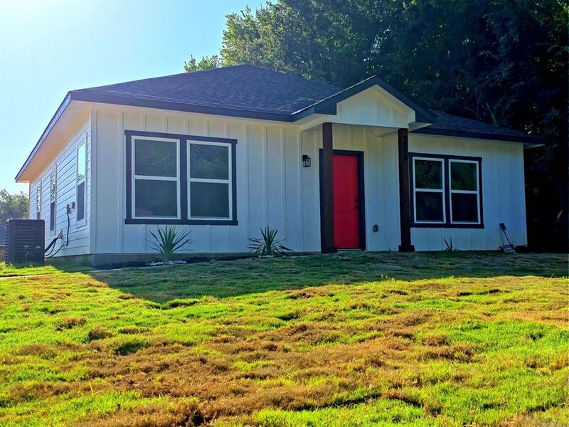 View of front of home featuring board and batten siding, a front yard, and roof with shingles View of front of home featuring board and batten siding, a front yard, and roof with shingles