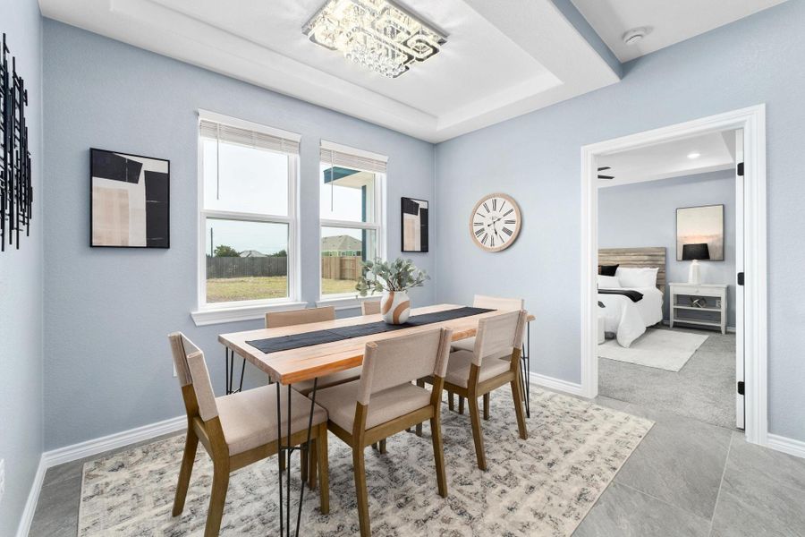 Dining area with baseboards and a raised ceiling Dining area with baseboards and a raised ceiling