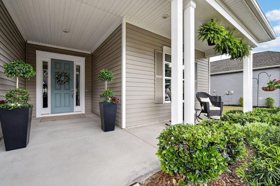 Exterior details and patio area of a home in K. Hovnanian's® Four Seasons at Lakes of Cane Bay, Summerville (Image 4).