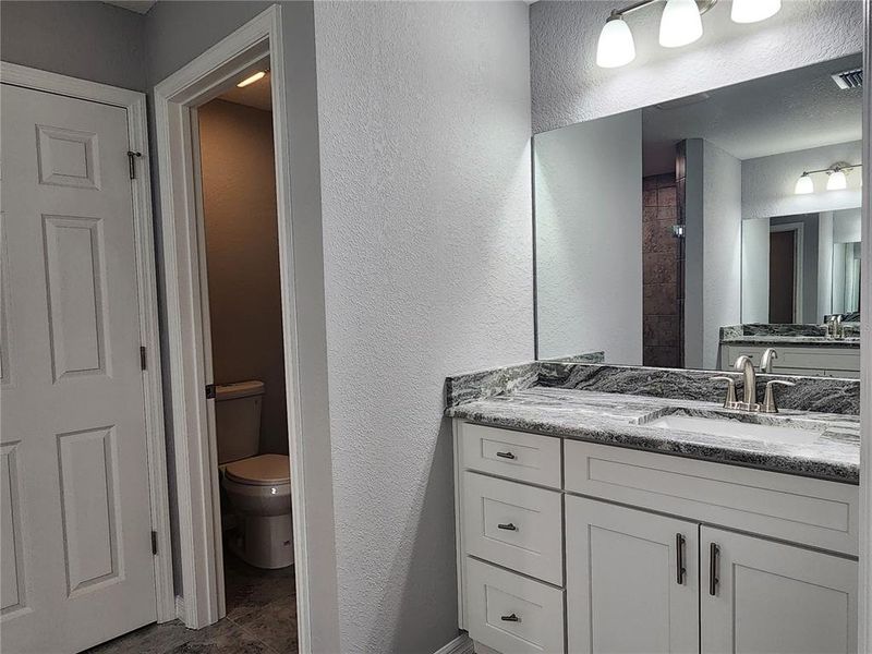 Primary Bathroom with private commode and linen closet