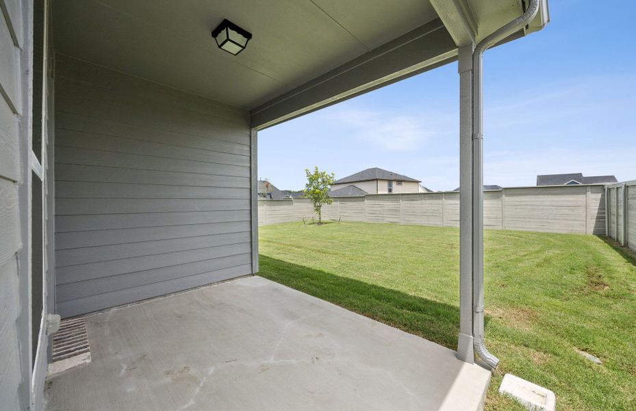 Oversized yard with covered patio  *Real home pictured