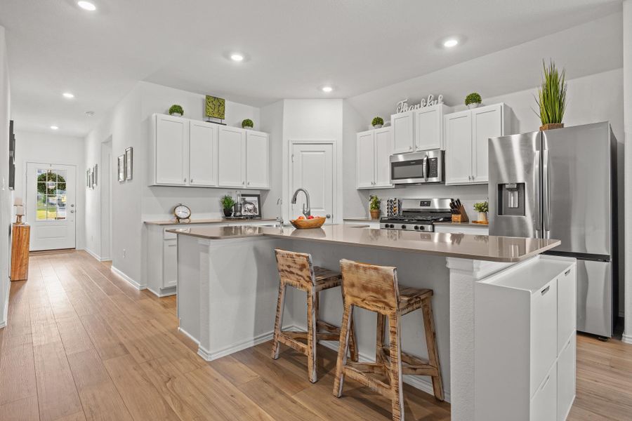Culinary delights await in this modern kitchen with ample counter space and abundant cabinetry, perfect for entertaining. Culinary delights await in this modern kitchen with ample counter space and abundant cabinetry, perfect for entertaining.