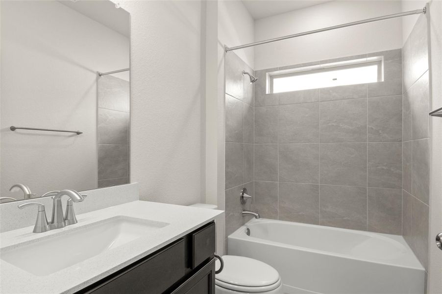 Bathroom with vanity and shower / tub combination