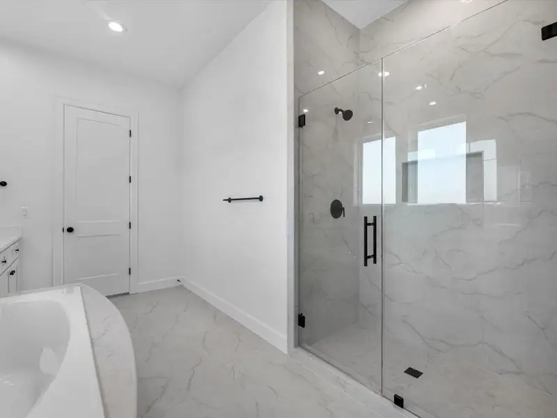 Large, frameless shower w/ floor to ceiling surround Large, frameless shower w/ floor to ceiling surround