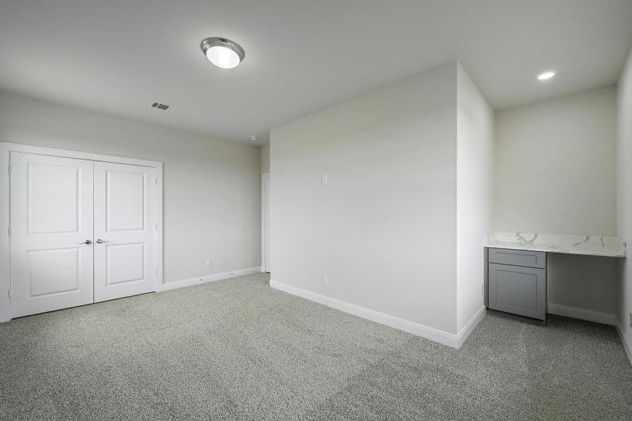 Unfurnished bedroom featuring light colored carpet and a closet Unfurnished bedroom featuring light colored carpet and a closet