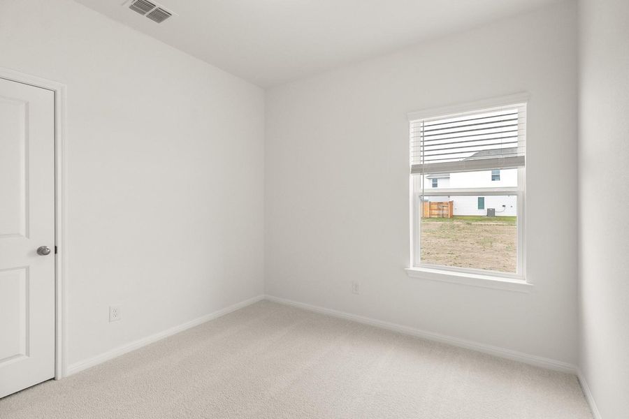 Spare room with light carpet and baseboards