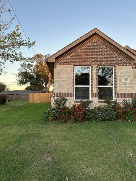 Property exterior at dusk with a lawn