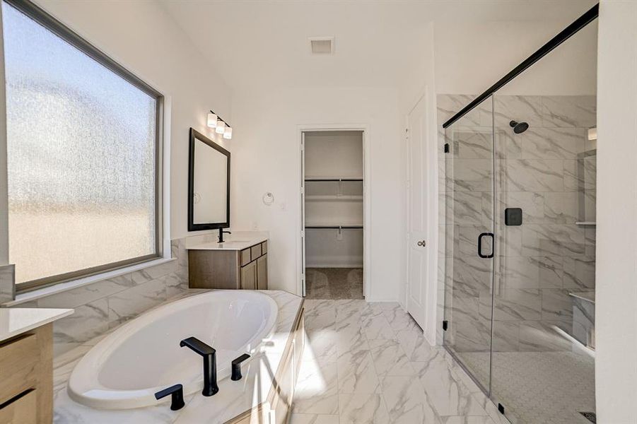 Beautiful upgraded tile throughout the primary bath and shower space.