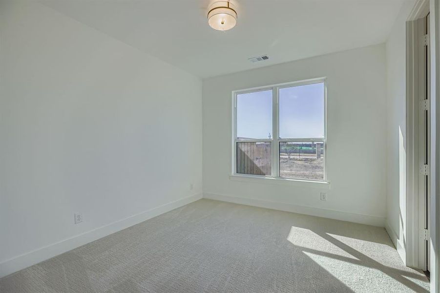 Empty room with carpet and baseboards