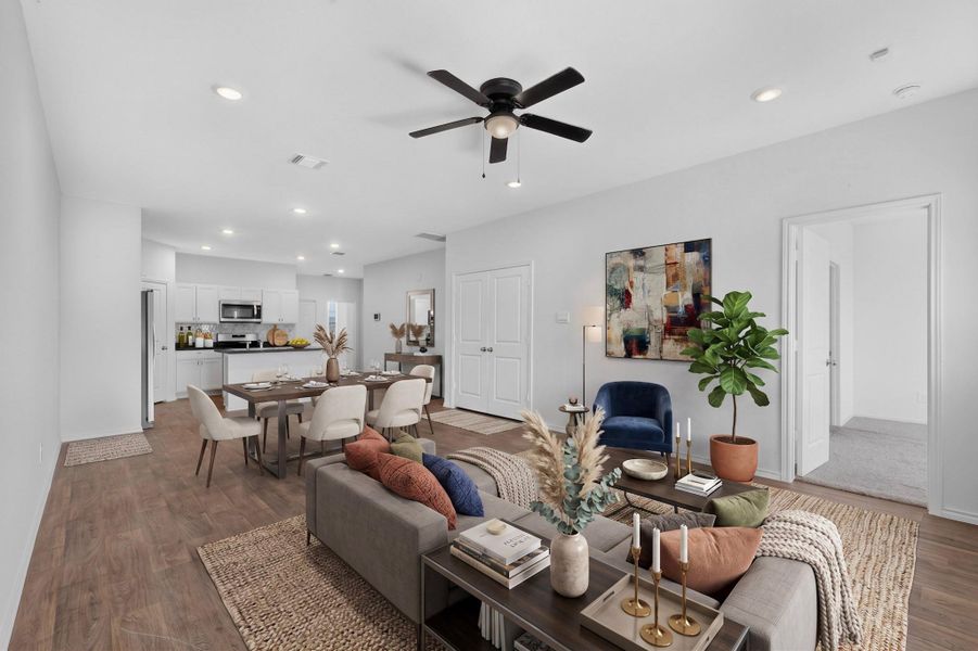 An open floorplan design connects the spacious living and dining areas with durable wood-style flooring. An open floorplan design connects the spacious living and dining areas with durable wood-style flooring.