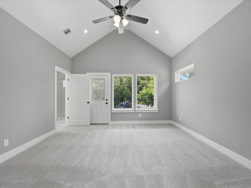 High ceilings, plentiful natural light, and a private balcony enhance the spacious feel of the private primary retreat. High ceilings, plentiful natural light, and a private balcony enhance the spacious feel of the private primary retreat.