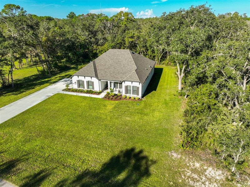Front exterior of a new home in Bella Terra, Hudson, FL, highlighting curb appeal (Image 2).