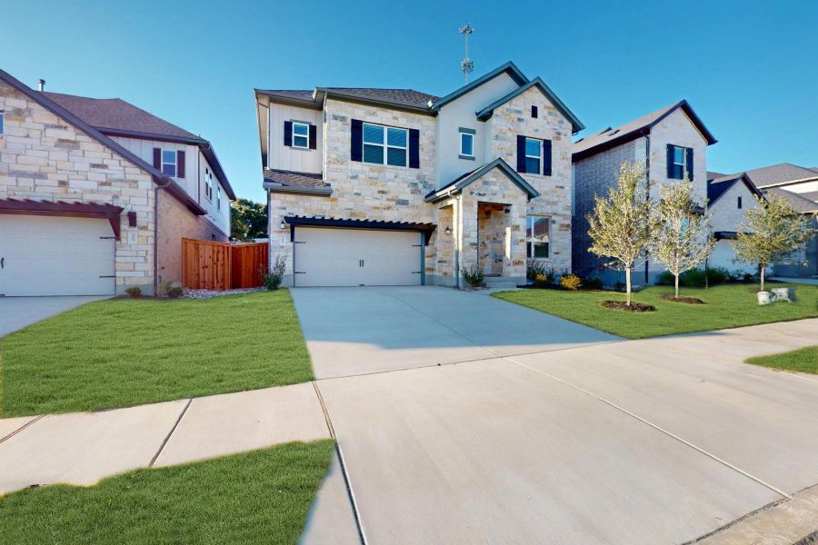 Front exterior of a new home in Edgewood, Leander, TX, highlighting curb appeal (Image 16). Front exterior of a new home in Edgewood, Leander, TX, highlighting curb appeal (Image 16).