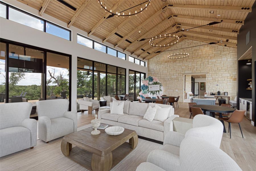 Living area with a chandelier, a high wood ceiling, and healthy amount of natural light