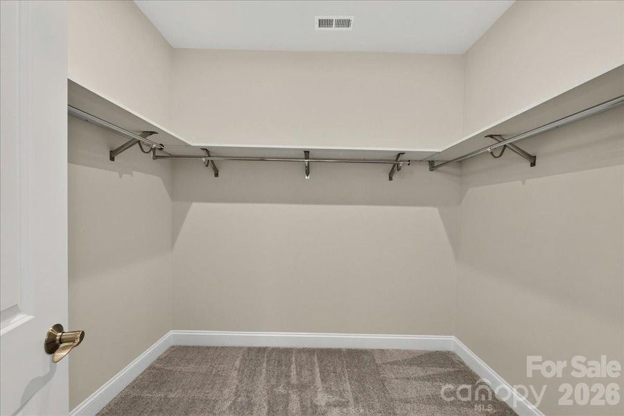 Primary walk-in closet with upgraded shelving Primary walk-in closet with upgraded shelving
