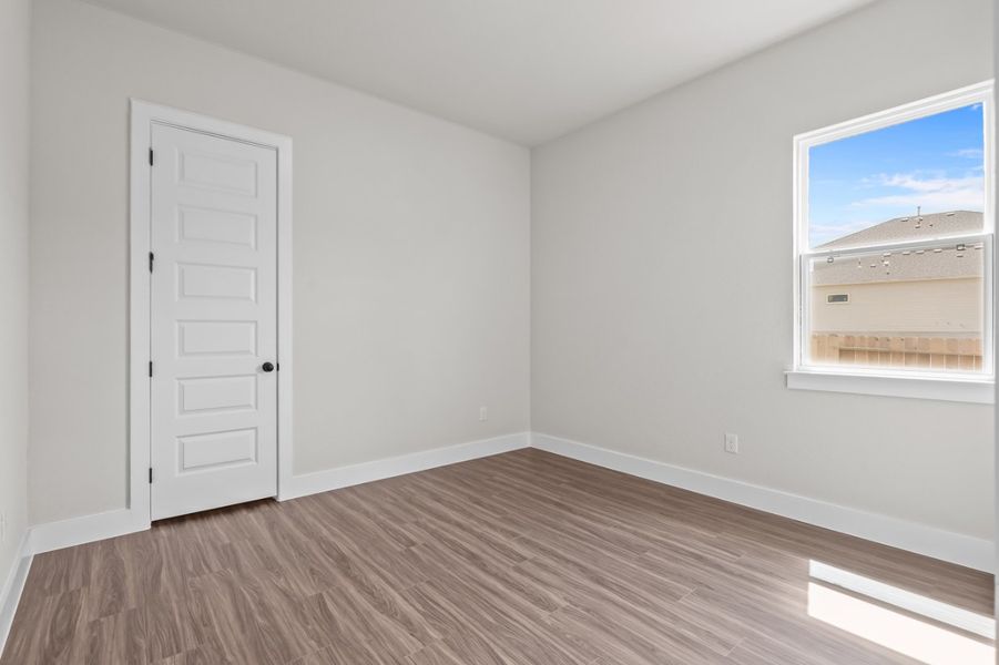 A room with a wood floor and white walls. A room with a wood floor and white walls.