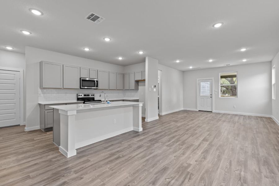 A kitchen with white cabinets.